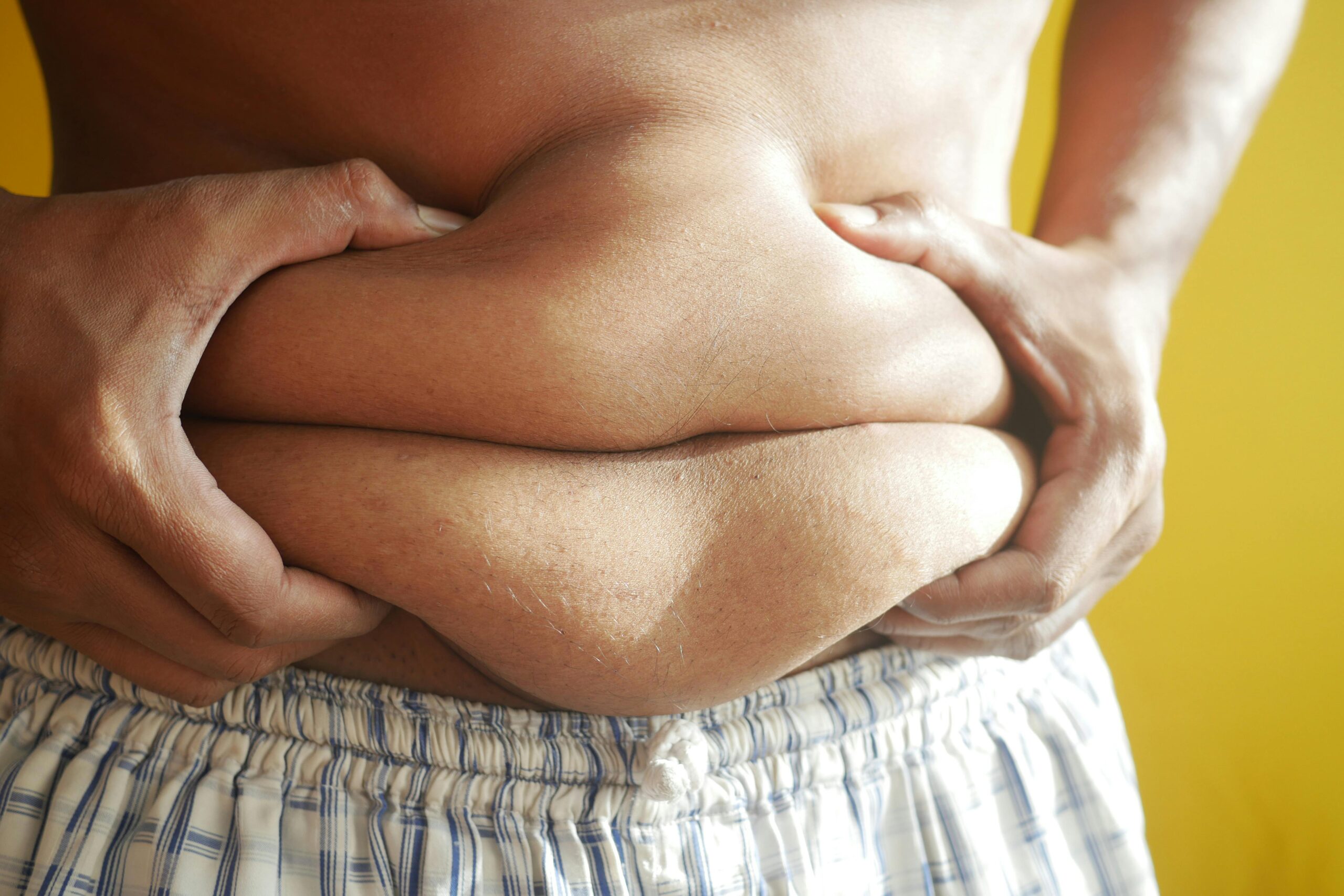 Person holding their abdominal area